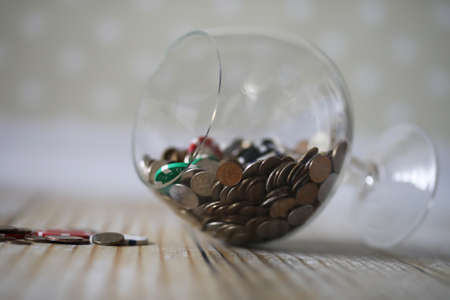 Accumulated coins stacked in glass jarsの写真素材