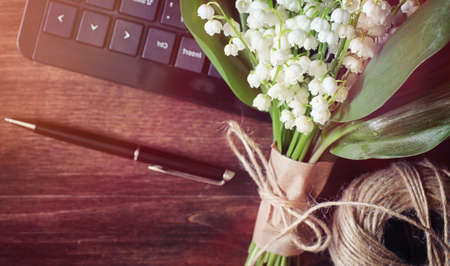 Bouquet of lilies of the valley on a tableの写真素材