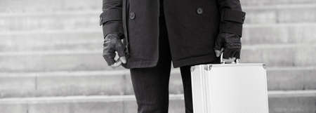 Asian man with a metal suitcase in the city. Asian and silver case. Asian with a suitcase for killer. Detective with the goods in the case.の写真素材