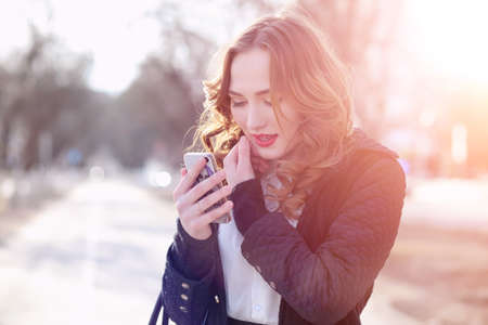 Girl business woman in the spring on a walk in a coatの写真素材