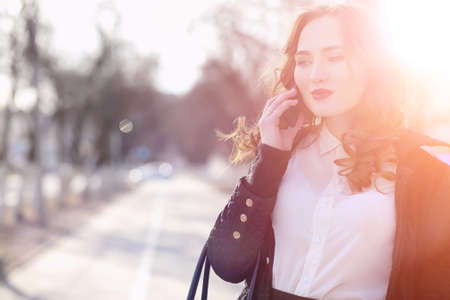 Girl business woman in the spring on a walk in a coatの写真素材