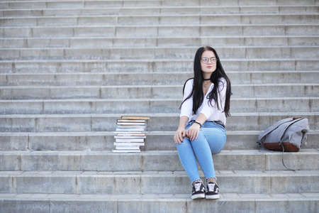 Girl student on the street with booksの写真素材