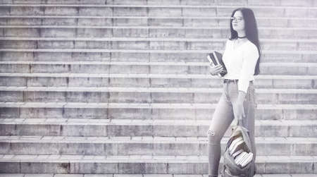 Young girl student on the streetの写真素材