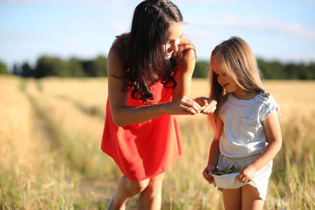 Summer landscape and a girl on nature walk in the countryside.の写真素材