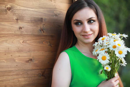 beautiful girl with red hair with a bouquetの写真素材
