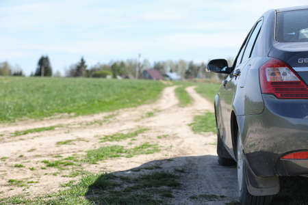 The car is parked in the field. The car is driving along the rurの写真素材