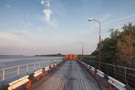 Wooden bridge on the river bank. A wooden road with pillars. Panの写真素材