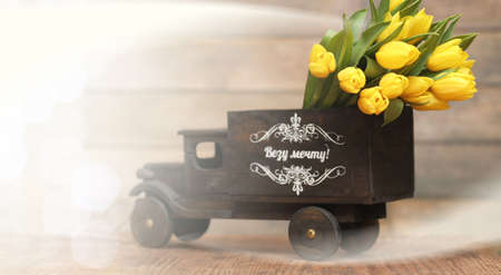 bouquet of yellow tulips in a vase on the floorの写真素材