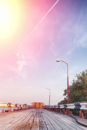 Wooden bridge on the river bank. Wooden road with pillars. Pantone wooden bridge.の写真素材