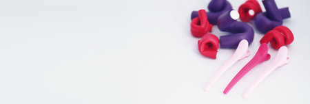 Female colored curlers and hair pins on the tableの写真素材