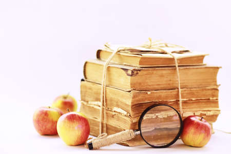 A stack of old vintage books on a white tableの写真素材