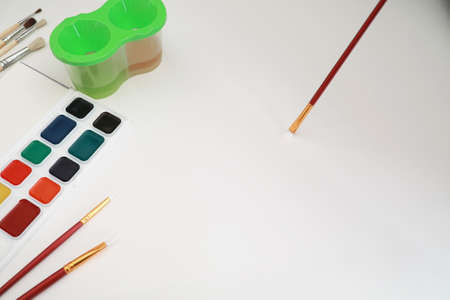 Stationery for drawing paints on a white sheet of paperの写真素材