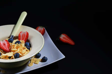 Ready breakfast corn flakes with fresh berriesの写真素材