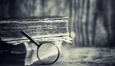 An old retro book on the table. An encyclopedia of the past on an old wooden countertop. An old book from the bibiotics, a folio, a constitution, bible.の写真素材