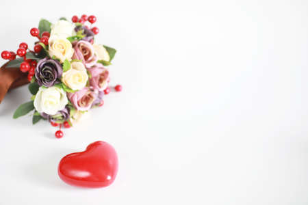Bouquet of flowers on a white background and a figure in the shape of a heartの写真素材