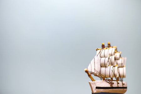 Old wooden ship with sails and masts toy on a stand. Vintage and retro toys