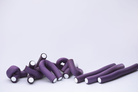 Female colored curlers and hair pins on the table