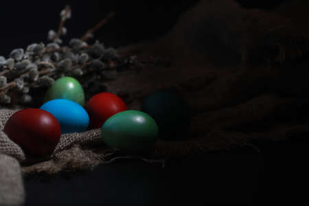 Easter painted eggs on burlap and strawの写真素材