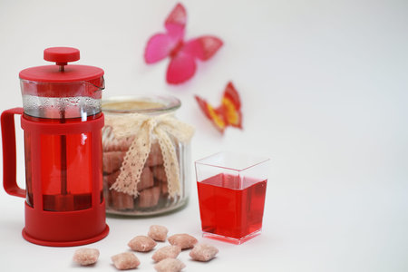 Female drink red warm tea on the table