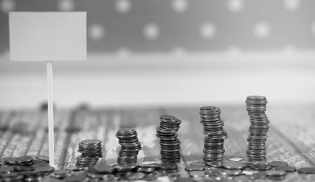 Coins in a jar on the floor. Accumulated coins on the floor. Pocket savings in piles.