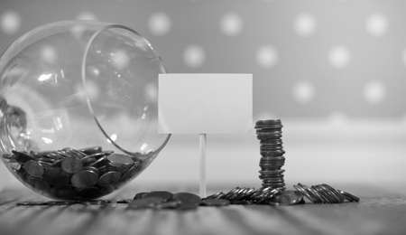 Coins in a jar on the floor. Accumulated coins on the floor. Pocket savings in piles.の写真素材