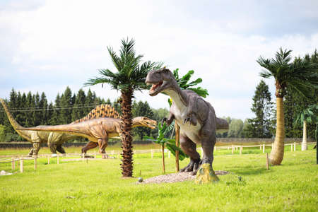 Park of dinosaurs. A dinosaur on the background of nature. Toy dinosaurs in amusement park.の写真素材