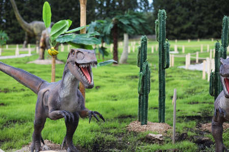 Park of dinosaurs. A dinosaur on the background of nature. Toy dinosaurs in amusement park.の写真素材