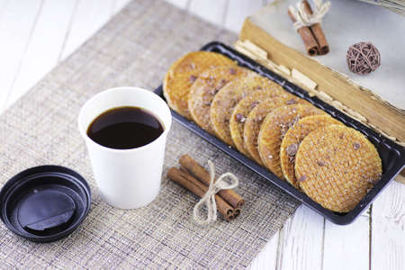 Viennese wafers with caramel on a wooden white backgroundの写真素材