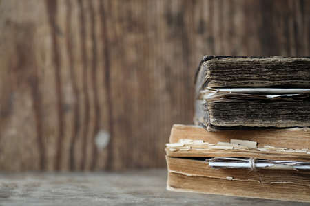 Old books on a wooden table and glass magnifierの写真素材