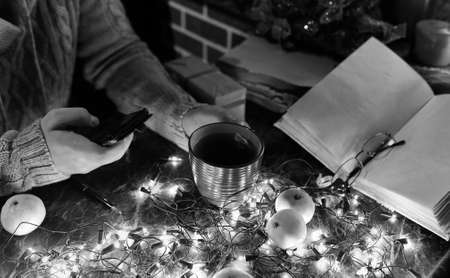 a man with a blank book in his hands for the New Year's table with decorationsの写真素材