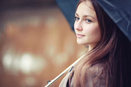 Young girl in a coat in autumn  parkの写真素材