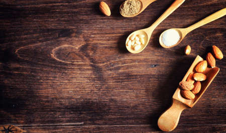 Charlotte with apples and nuts. Preparation of apple baking with nuts and honey. Dessert baked goods from apples and nuts with honey on a wooden table.の写真素材