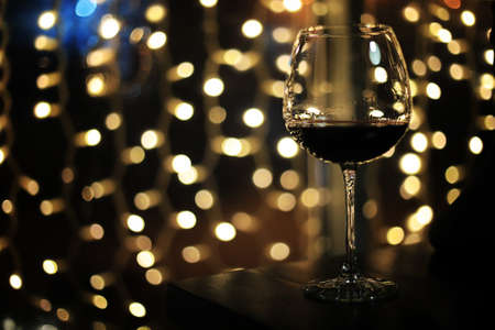 A glass of alcohol with ice in a nightclubの写真素材