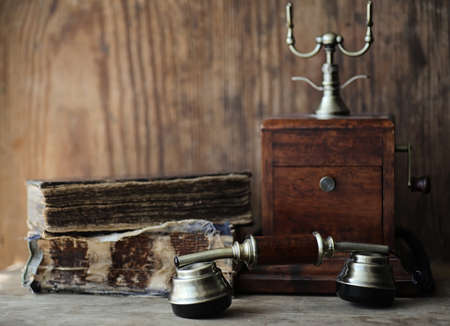 Old telephone and retro book on a wooden tableの写真素材