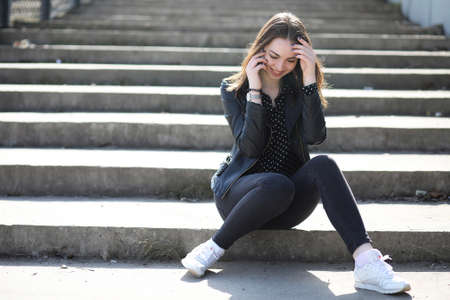Girl on a walk through the spring cityの写真素材