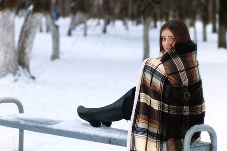 Young beautiful girl in winter snowy day