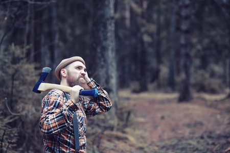 Autumn rainy weather and a young man with an umbrellaの写真素材