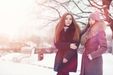 A young girl in a winter park on a walk. Christmas holidays in tの写真素材