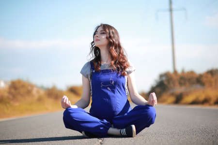 Pregnant woman  on the road yogaの写真素材