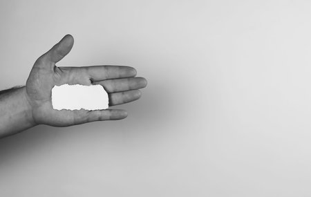 a small white piece of paper in his hand man