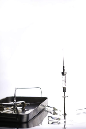 Old retro metal medical syringe and accessories on the tableの写真素材