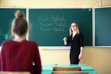 Young teacher in school classの写真素材