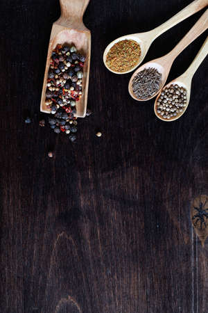 Mixture of peppers for cooking on a wooden backgroundの写真素材