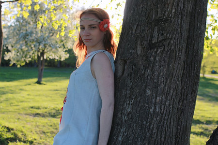 A girl on a walk in an autumn park. Young red-haired girl in the park