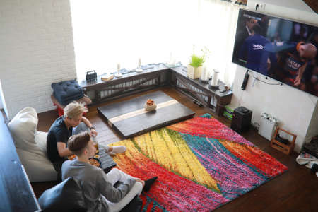 Football fans watching a match and drinking beerの写真素材