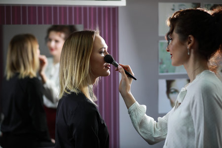 Young girl with a make-up artist