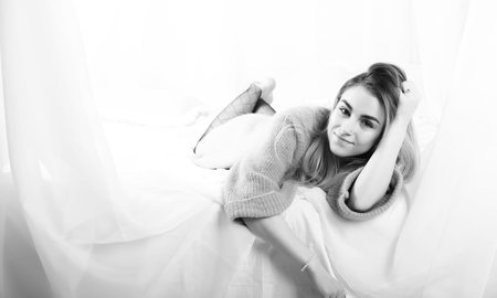 Young girl in a sweater in a room