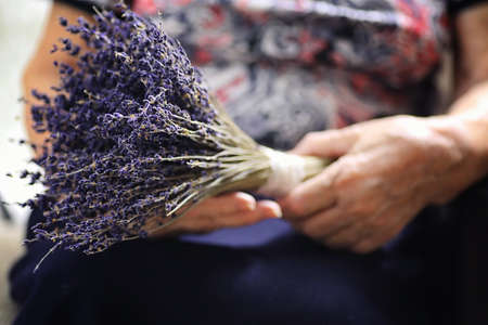 elder woman holding bouquetの写真素材