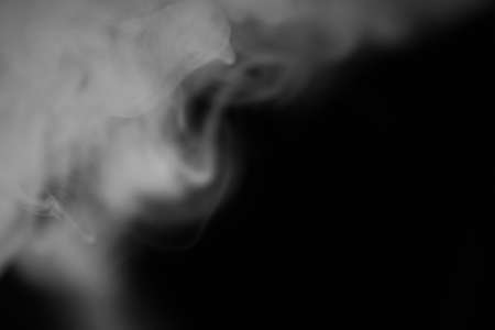 White smoke on a black background. Texture of smoke.の写真素材