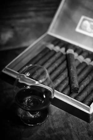 Retro styled photo of large box of Cuban cigars on a wooden table in a presentable packageの写真素材